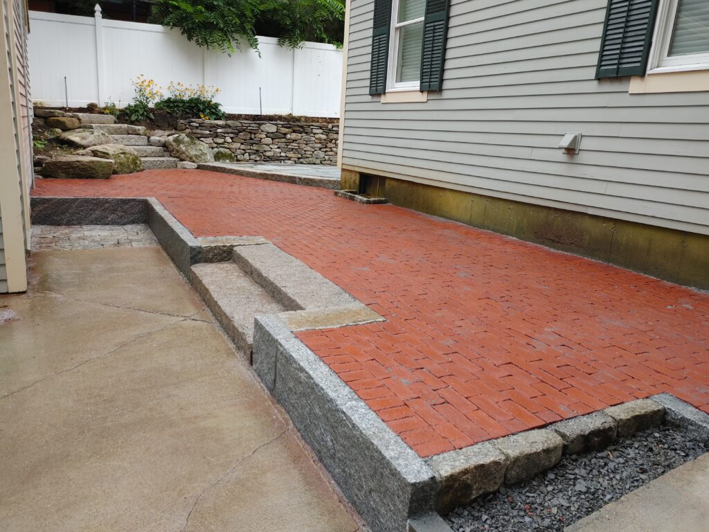 Patio featuring brick and New England stone