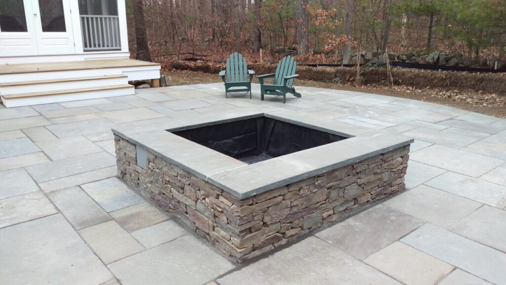 square shaped pond featuring New England stone
